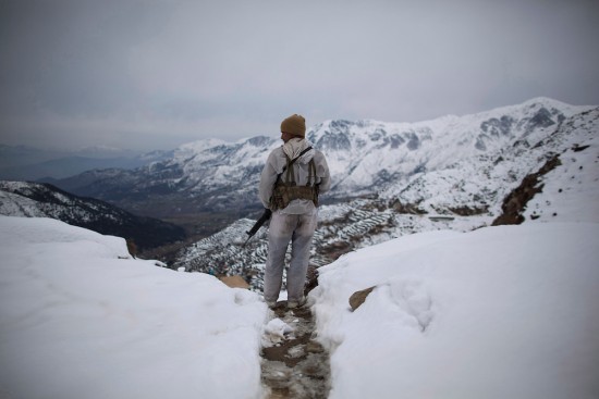 A Pakistani Army soldier with the 20th Lancers Armored Regiment, stands atop the 8000 foot mountain during a patrol near his outpost Kalpani Base in Pakistan's Dir province on the Pakistan-Afghan border, Friday, Feb 17, 2012. Kalpani is on the front line in the 10-year war against militant Islamists, a war which partners Pakistan with the United States and NATO. The partnership has been an uneasy one and at times the United States and Pakistan seem more enemies than friends. (AP Photo/Anja Niedringhaus)